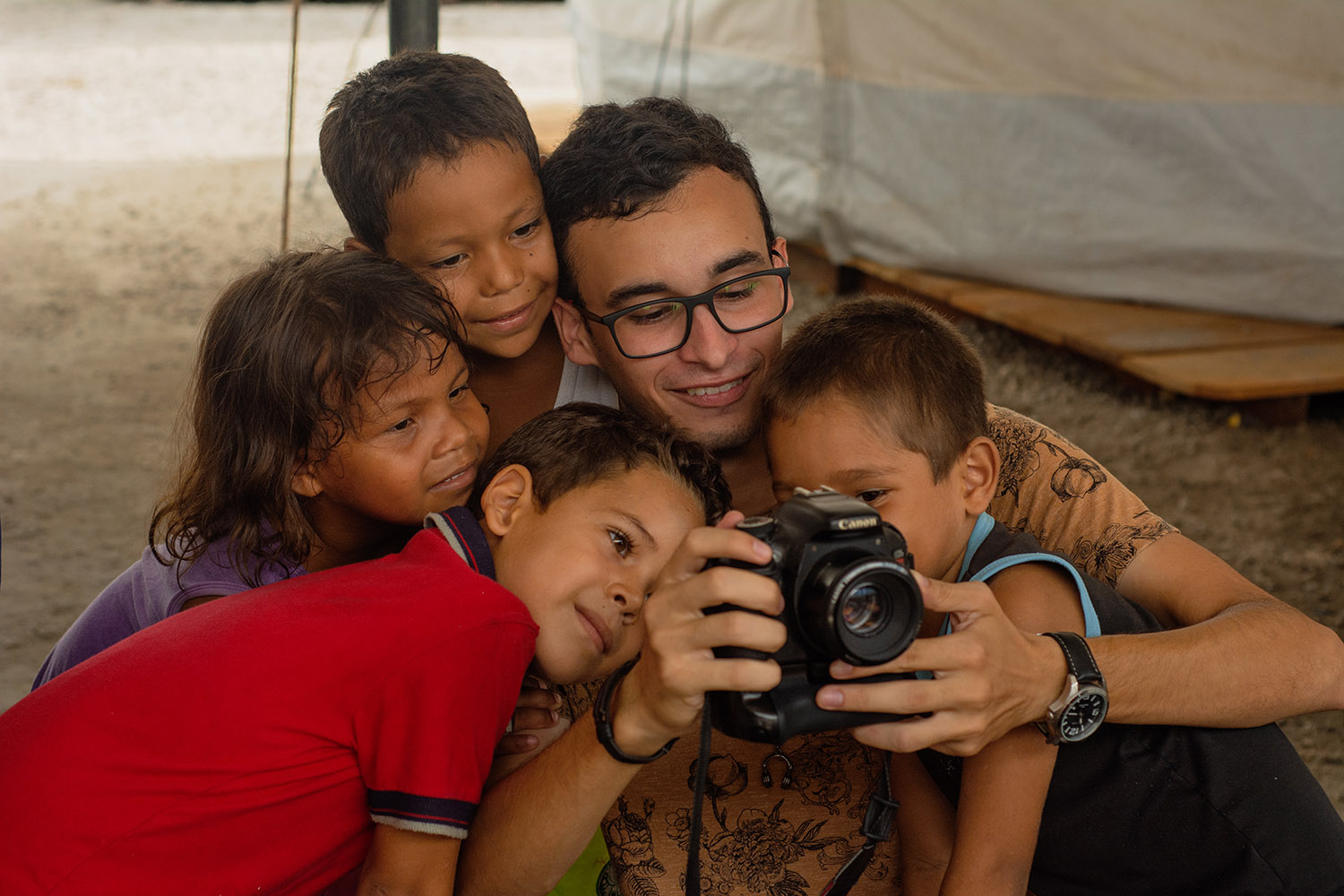 Integrante do projeto Estórias Migrantes com crianças venezuelanas em abrigo de Boa Vista: equipe compartilha experiências com a comunidade de migrantes (Foto: Kataryna Górka)
