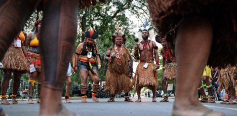 Brazilian indigenous men perform a ritual dance during a protest against the government's decision not to recognize the land demarcation of indigenous people living in Raposa Serra do Sol, Roraima State, in Brasilia, on April 25, 2018. - About 2,500 indigenous people from different tribes are taking part in the Indigenous National Mobilization (MNI) week - a mobilization which seeks to tackle territorial rights' negotiations with the government. (Photo by CARL DE SOUZA / AFP)