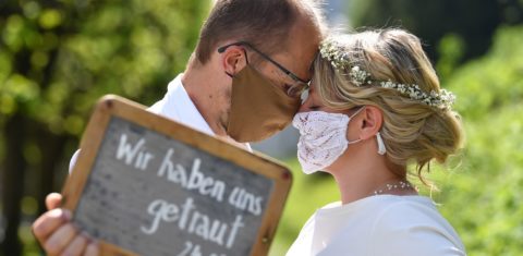 O casal austríaco Sigrun e Franz faz a sua cerimônia de casamento em meio à pandemia. No cartaz: "Nós ousamos". Foto Barbara Gindl/AFP