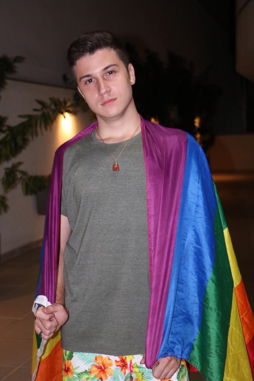 Arthur Souto, 21 anos, segurando a bandeira LGBT+. Foto: Rogério Fontes