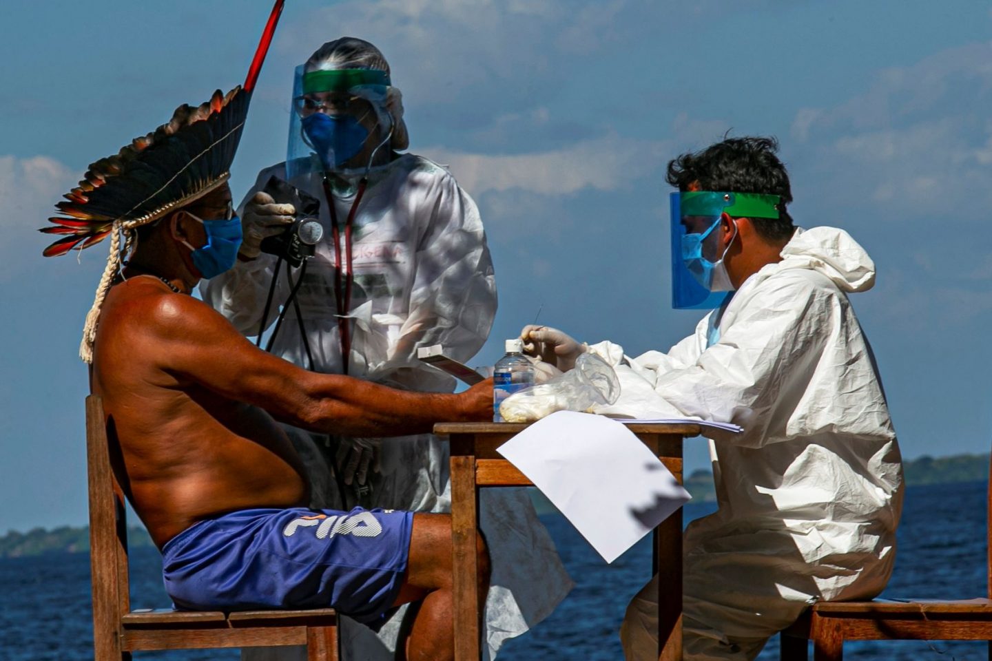 Enfermeiros indígenas da Sesai testam o cacique Domingos, da etnia Arapium, em aldeia às margens do Rio Tapajós, perto de Santarém, no Pará: Amazônia brasileira tem mais de 12 mil indígenas com covid-19 (Foto: Tarso Sarraf/AFP)