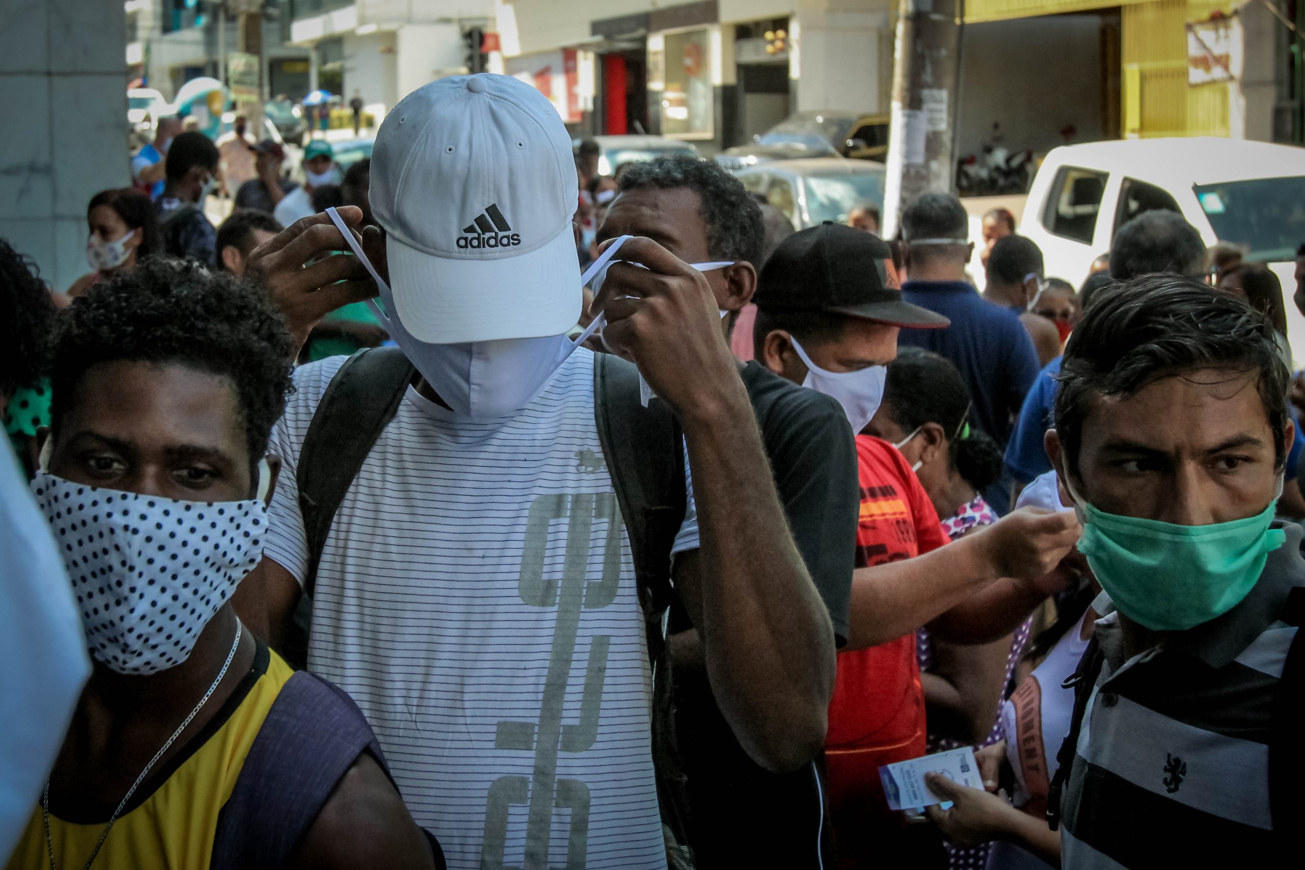 Distribuição de máscaras, com aglomeração, no Centro de Cuiabá, capital de Mato Grosso: estado bateu recorde de mortes em 24h no último dia de junho (Foto: Christiano Antonucci/Governo de Mato Grosso)