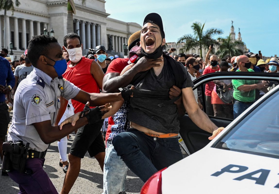 Polícia prende manifestante contra o governo de Cuba, durante protestos em Havana: clamores por democracia. Foto Yamil Lage/AFP