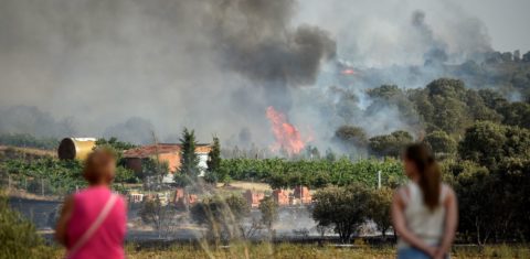 Espanholas observam incêndio florestal que ameaça casas no sudoeste do país: especialistas alertam que onda de calor é só o começo do agravamento da crise climática (Foto: Miguel Rioja / AFP)