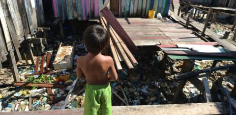Menino em área sem acesso à rede de esgoto no Complexo da Maré, no Rio: levantamento indica que 41,7% das crianças de 0 a 5 anos não têm acesso a saneamento em seus domicílios (Foto: Marcello Casal Jr. / Agência Brasil)