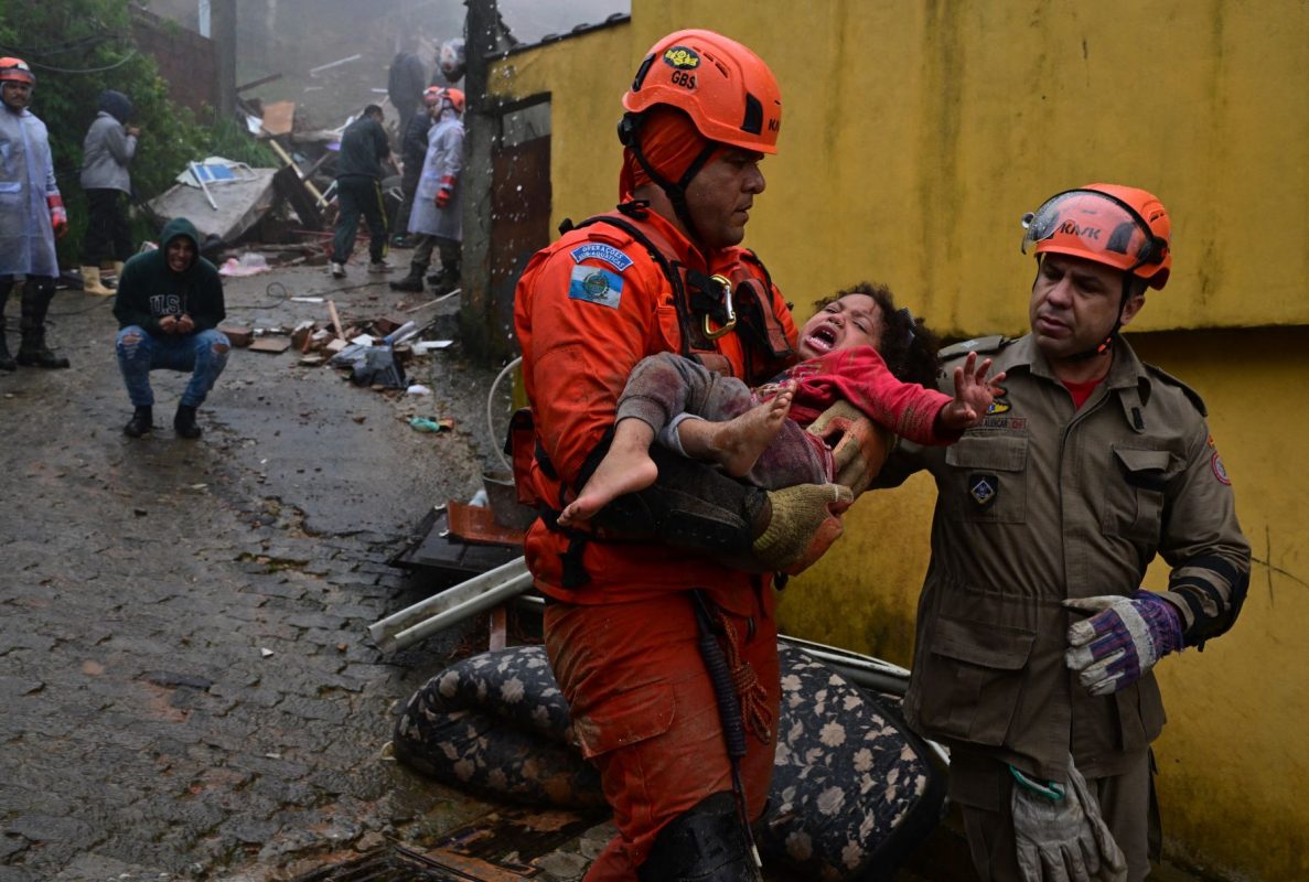 Bombeiros retiram a menina Ayla dos escombros em Petrópolis: tragédia climática repetida aponta para o fracasso da humanidade (Foto: Pablo Porciúncula / AFP - 23/03/2024)