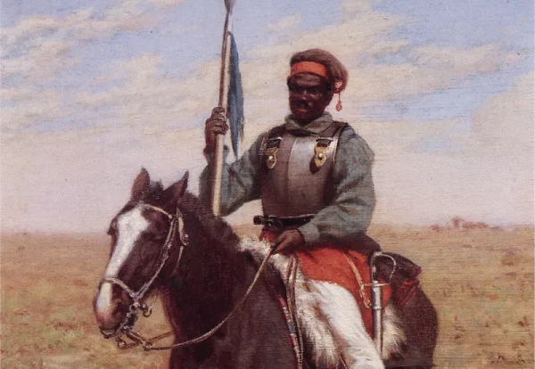 Ilustração colorida de lanceiro negro a cavalo. O lanceiro utiliza vestimentas de batalha e empunha uma lança com uma bandeira ao lado do corpo. Ao fundo, campo e céu.