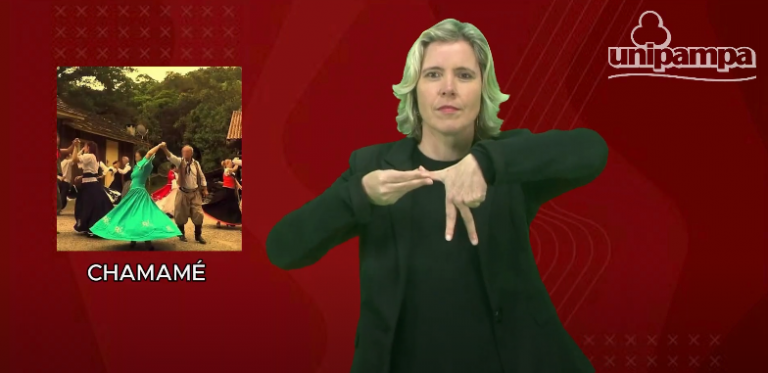 Captura de tela colorida do sinalário gaúcho de Libras. Na imagem, a professora Keli Krause aparece sinalizando a palavra chamamé. No lado esquerdo, aparece uma foto de pessoas dançando e o fundo é vermelho. Regionalismo em Libras
