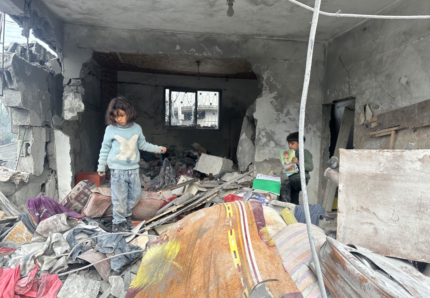 Crianças em casa destruída em Gaza por bombardeio de Israel após acordo de cessar-fogo: o que fica depois que a guerra acaba? (Foto: Hasan N. H. Alzaanin / Anadolu via AFP)