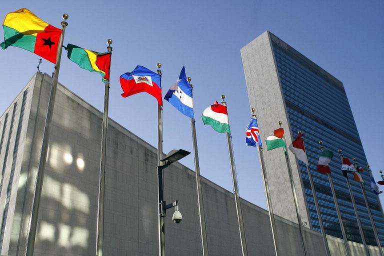 Foto colorida do prédio da Corte Internacional de Justiça com várias bandeiras tremulando; imagem ilustra votação para definir se mudança do clima é obrigação legal dos países