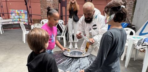 O 'astronauta' Rona Naves e crianças com a Nave Memória: oficina convida meninos e meninas a trabalharem as percepções sobre o futuro, por meio de cartas e desenhos (Foto: Sofia Ricardo)